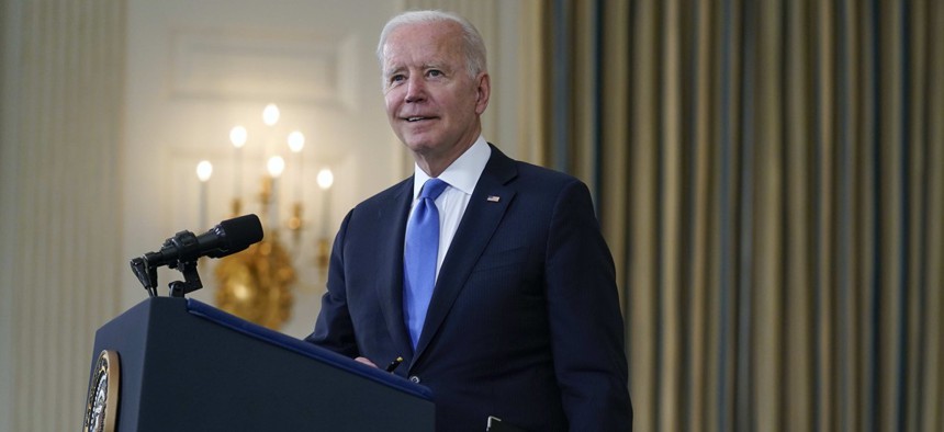 President Joe Biden takes questions from reporters as he speaks about the American Rescue Plan, in the State Dining Room of the White House.