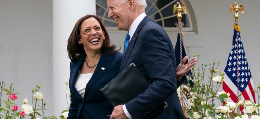 Vice President Kamala Harris and President Biden smile and walk off after speaking about updated guidance on mask mandates, in the Rose Garden of the White House on May 13. 