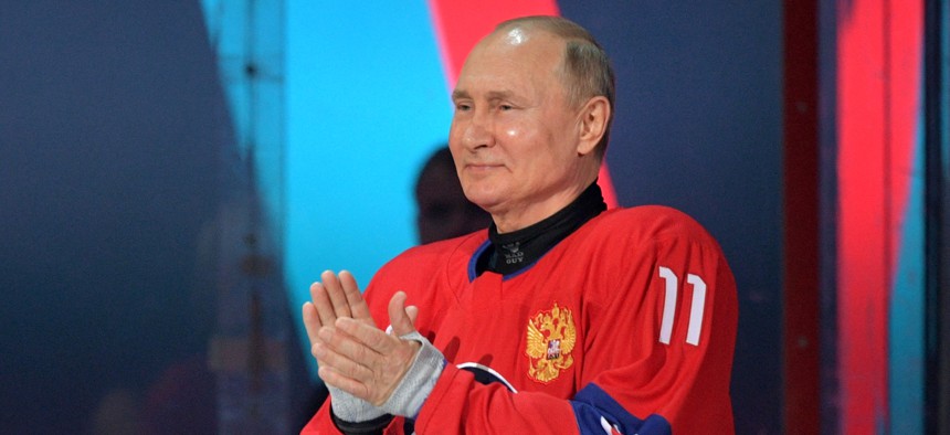 Russian President Vladimir Putin applauds as he attends the opening ceremony of the Night Hockey League gala-match at the Bolshoy Ice Dome in Sochi, on May 10, 2021. 