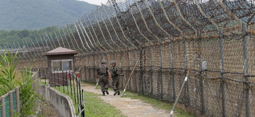 In this June 14, 2019, file photo, South Korean army soldiers patrol while hikers visit the DMZ Peace Trail in the demilitarized zone in Goseong, South Korea.