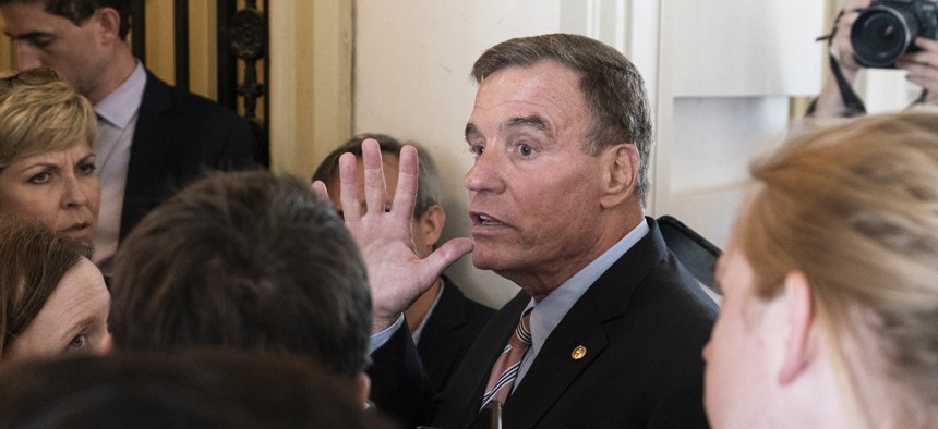 Sen. Mark Warner, D-Va., speaks with reporters upon returning to the Capitol after a meeting with President Joe Biden at the White House in Washington, Thursday, June 24, 2021. A bipartisan group of lawmakers have negotiated a plan to pay for an estimated $1 trillion compromise plan.