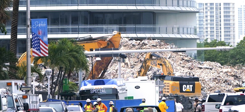 Crews work in the rubble of the Champlain Towers South building, as removal and recovery work continues at the site of the partially collapsed condo building, Tuesday, July 13, 2021, in Surfside, Fla.