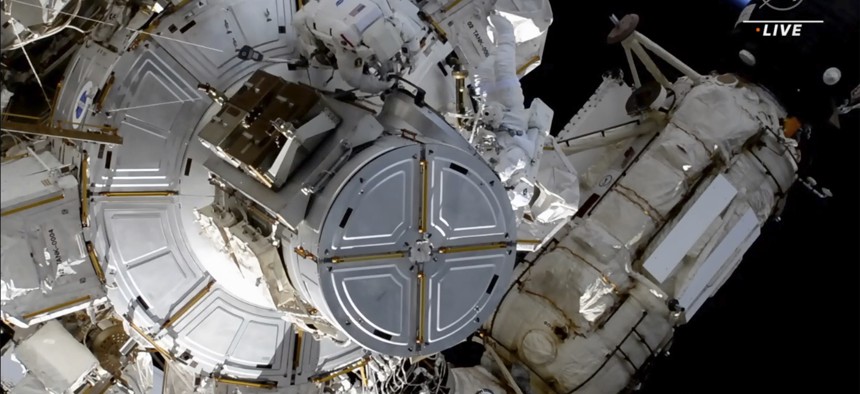 This photo provided by NASA shows astronauts NASA's Shane Kimbrough and France's Thomas Pesquet during a space walk outside the International Space Station on Friday, June 25, 2021. The astronauts are working to install another new solar panel outside the station.