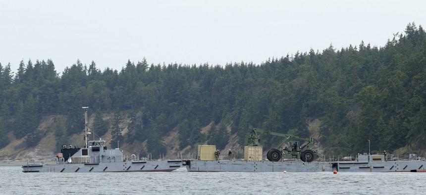 U.S. Navy sailors move a cargo container from a modular barge to shore, Wednesday, June 8, 2016, on Naval Magazine Indian Island in Washington state, as part of a massive earthquake and tsunami drill called Cascadia Rising. The drill is built around the premise of a 9.0 magnitude earthquake 95 miles off of the coast of Oregon that results in a tsunami.