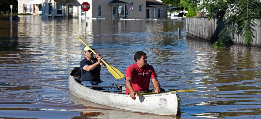 Residents canoe through floodwater in the aftermath of Hurricane Ida in Manville, N.J., on Thursday. 