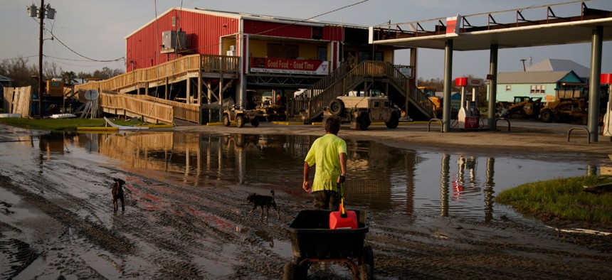 A man goes for gas at a hurricane-damaged gas station in the aftermath of Hurricane Ida on September 6 in Grand Isle, La. 