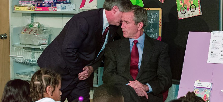 In this Tuesday, Sept. 11, 2001 file photo, White House chief of staff Andrew Card whispers into the ear of President George W. Bush to give him word of the plane crashes into the World Trade Center, during a visit to the Emma E. Booker Elementary School in Sarasota, Fla. 