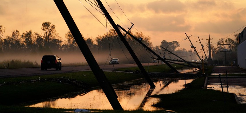 Downed power lines slump over a road in the aftermath of Hurricane Ida, Friday, Sept. 3, 2021, in Reserve, La. 