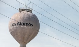 Los Alamos, USA - June 17, 2019: City in New Mexico with view of water tower tank on road with sign for National Laboratory
