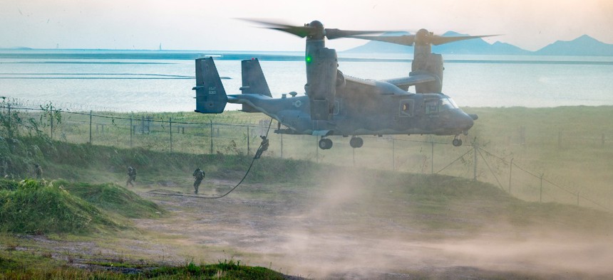 Air Force Special Tactics airmen fast rope from a CV-22 Osprey during Teak Knife training at Kunsan Air Base, Republic of Korea, Sept. 9.