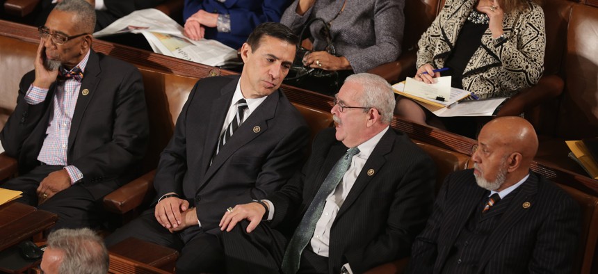 Reps. Darrell Issa (R-Calif.) and Gerry Connolly (D-Va.) chat during opening session of the 114th Congress at the U.S. Capitol January 6, 2015. The pair are flanked by Reps. Bobby Rush (D-Ill.) and Alcee Hastings, now deceased, on the right.