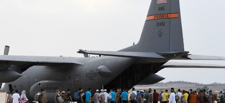 Refugees board a US aircraft heading to Germany, after being evacuated from Kabul during an evacuation flight, at the Torrejon de Ardoz air base, 30 km from Madrid, on August 24, 2021.