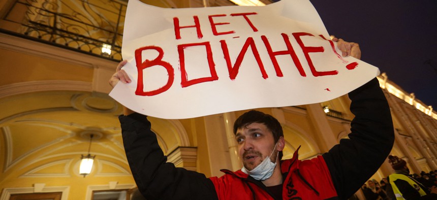 A man holding up a placard reading "No to war!" protests against Russia's invasion of Ukraine in Saint Petersburg on February 24, 2022.