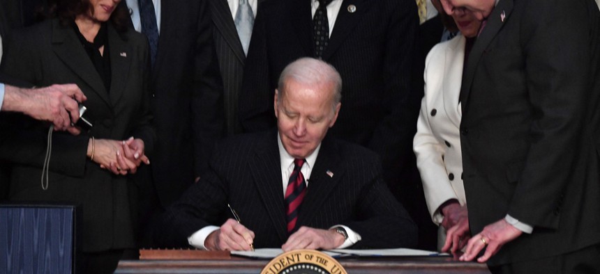 President Biden signs the omnibus spending bill into law, March 15, 2022.