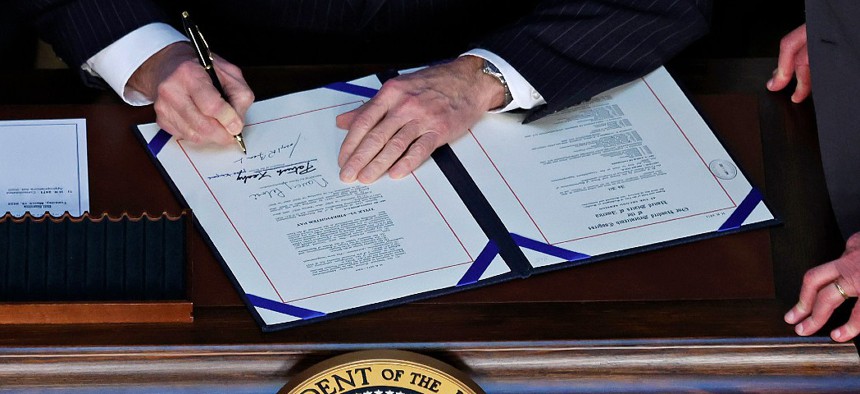 U.S. President Joe Biden signs the “Consolidated Appropriations Act" in the Indian Treaty Room in the Eisenhower Executive Office Building on March 15, 2022 in Washington, DC.