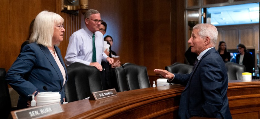 Bill sponsors Sens. Patty Murray, D-Wash., and Richard Burr, R-N.C. (center) speak to Dr. Anthony Fauci, director of the National Institute of Allergy and Infectious Diseases, after a hearing in July 2021. 