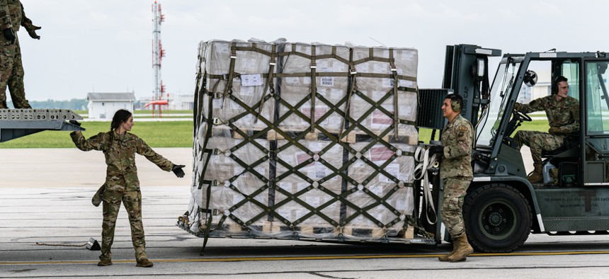 Airmen unload pallets of baby formula flown from Europe at Indianapolis Airport on May 22, 2022.