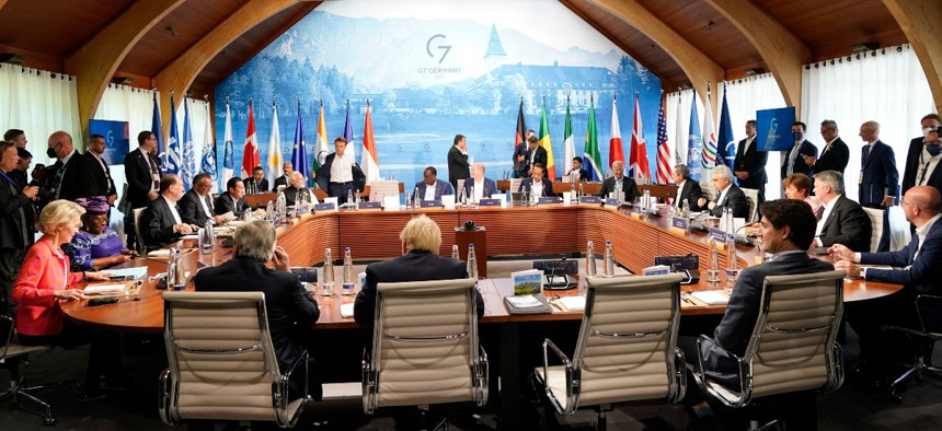 Representatives of Seven rich nations (G7) and Outreach guests are pictured at the start of their fifth working session about "Investing in a better future: Climate, Energy, Health" on June 27, 2022 at Elmau Castle, southern Germany, during the G7 Summit.