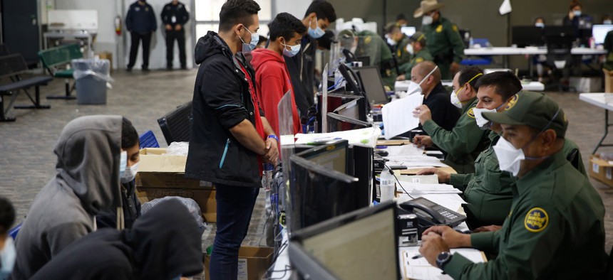 Migrants are processed at the intake area in the Department of Homeland Security holding facility run by the Customs and Border Protection on March 30, 2021 in Donna, Texas.