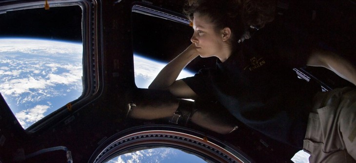 NASA astronaut Tracy Caldwell Dyson, Expedition 24 flight engineer, looks through a window in the Cupola of the International Space Station.