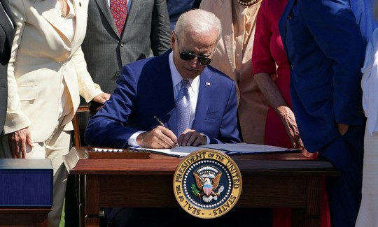 US President Joe Biden signs H.R. 4346, the CHIPS and Science Act of 2022, on the South Lawn of the White House in Washington, DC, on August 9, 2022. 
