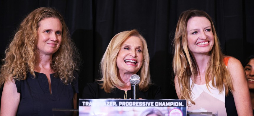 Rep. Carolyn Maloney (D-N.Y.), flanked by daughters Christina Maloney (L) and Virginia Maloney, speaks at an election-night gathering on Aug. 23 in New York City.