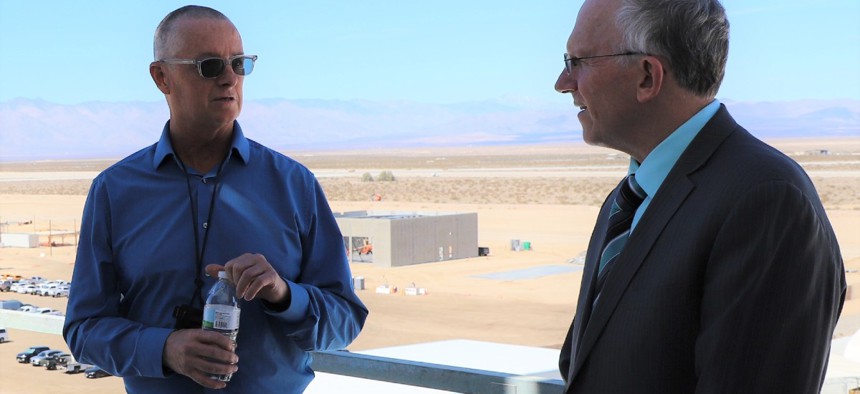 Operational Test and Evaluation Director Nickolas Guertin (right) tours Naval Air Weapons Station China Lake.