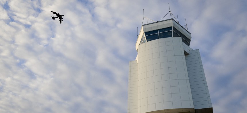 A B-52H Stratofortress flies above the Air Traffic Control Tower at Minot Air Force Base, N.D.