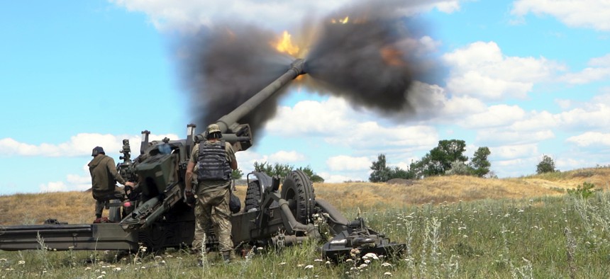 UKRAINE - JULY 18, 2022 - Ukrainian servicemen fire a towed howitzer in eastern Ukraine. This photo cannot be distributed in the Russian Federation. 