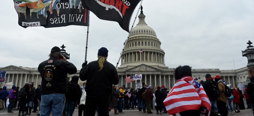 Supporters of Donald Trump hold a rally outside the Capitol as they protest the electoral college certification of Joe Biden as president on January 6, 2021.