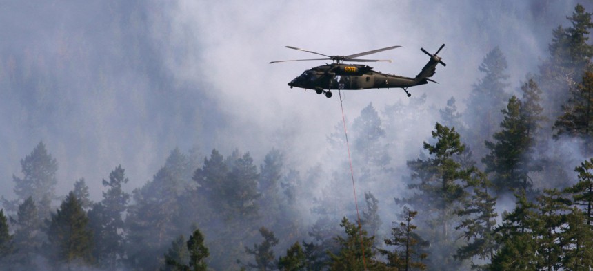 Oregon Army National Guard pilots navigate through smoke on the way to their drop site in support of firefighting ground crews in 2015.