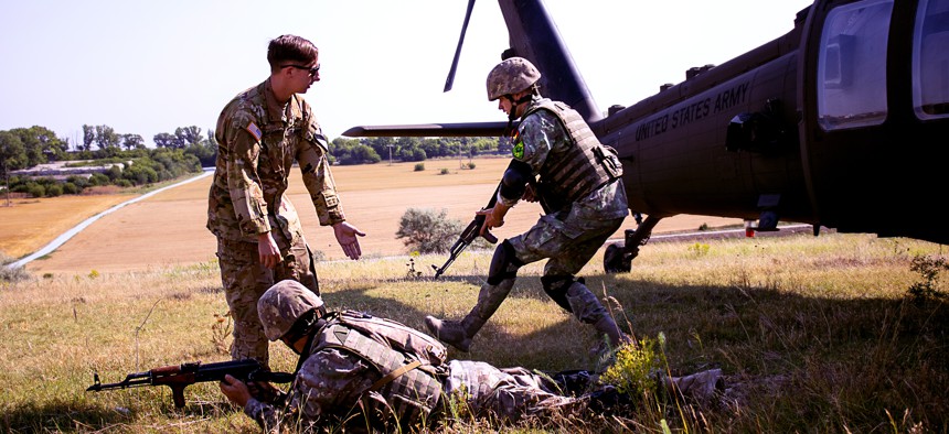 A U.S. soldier teaches air assault procedures to the Romanian 9th Mechanized Brigade in Mihail Kogalniceanu, Romania, July 5, 2022. 