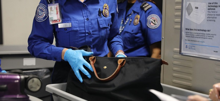 A Transportation Security Administration (TSA) worker screens luggage at LaGuardia Airport on September 26, 2017 in New York City. 
