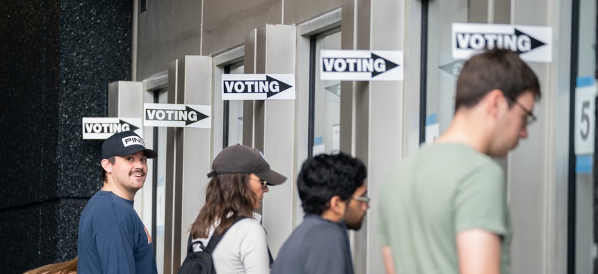 People check in for early voting at a polling location at Bank of America Stadium on November 5, 2022 in Charlotte, North Carolina.