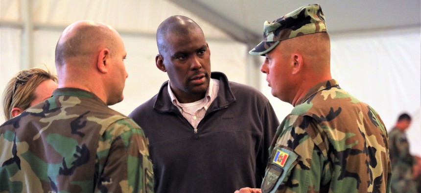 Ambassador Dereck Hogan, the principal deputy assistant secretary in the State Department’s Bureau of European and Eurasian Affairs, chats with Minister of Defense of Moldova Pavel Voicu, left, and Moldovan Army Lt. Col. Sergue Chilivnic, right, at Fort Irwin, California, on July 16, 2019. 