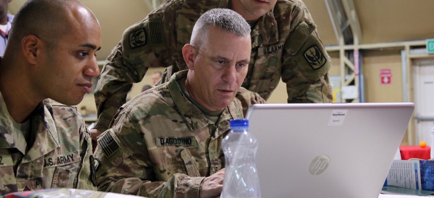 (From left to right) U.S. Army Staff Sgt. Melvin Vasquez, Chief Warrant Officer 3 Vincent D’Agostino and Capt. Jason Skoland, Soldiers assigned to the 449th Combat Aviation Brigade work together during the respond to an attack event of the fourth annual Best Cyber Ranger Competition at the Zone One Events Tent, Camp Arifjan, Kuwait, May 9, 2018.