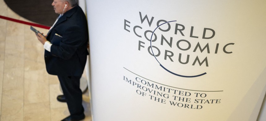 A participant uses his mobile phone at the Congress centre during the World Economic Forum (WEF) annual meeting in Davos on January 18, 2023.