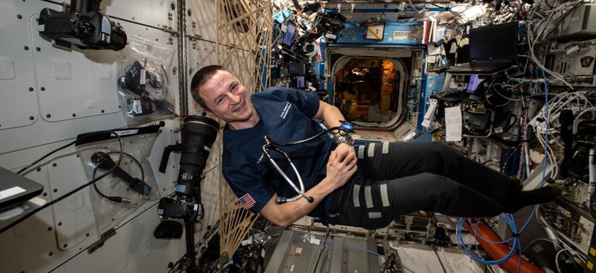 NASA astronaut Andrew Morgan poses for a portrait with a stethoscope for medical checks inside the U.S. Destiny laboratory module after an exercise session.
