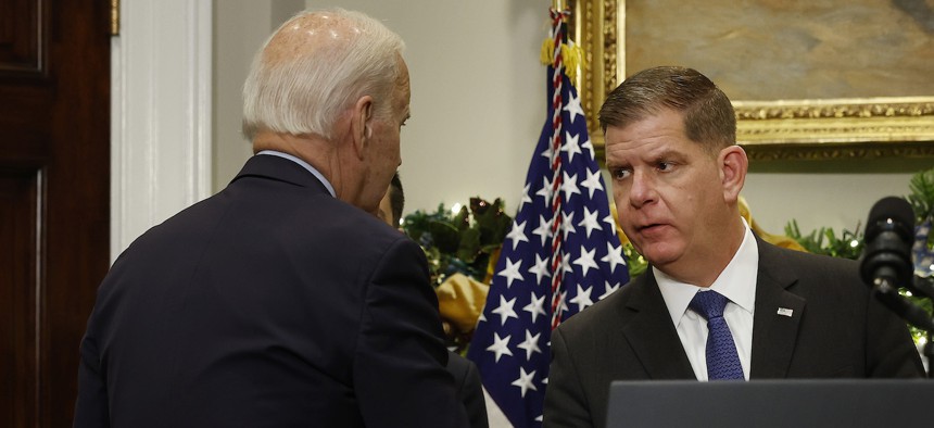 Labor Secretary Marty Walsh, shown here with President Biden in the White House last December, is said to be stepping down to lead the pro hockey players' union