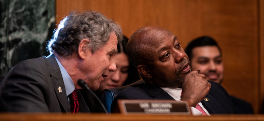 Chairman Sen. Sherrod Brown (D-OH) chats with ranking member Sen. Tim Scott (R-SC) during a Senate Banking, Housing, and Urban Affairs hearing to examine the crypto crash, focusing on why financial system safeguards are needed for digital assets on Capitol Hill on Tuesday, Feb. 14, 2023 in Washington, DC.