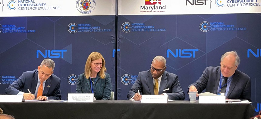  Deputy Secretary of Commerce Don Graves, Under Secretary of Commerce for Standards and Technology and NIST Director Laurie E. Locascio, Maryland Secretary of Commerce Kevin Anderson, and Montgomery County Executive Marc Elrich sign a partnership agreement at the NIST National Cybersecurity Center of Excellence.