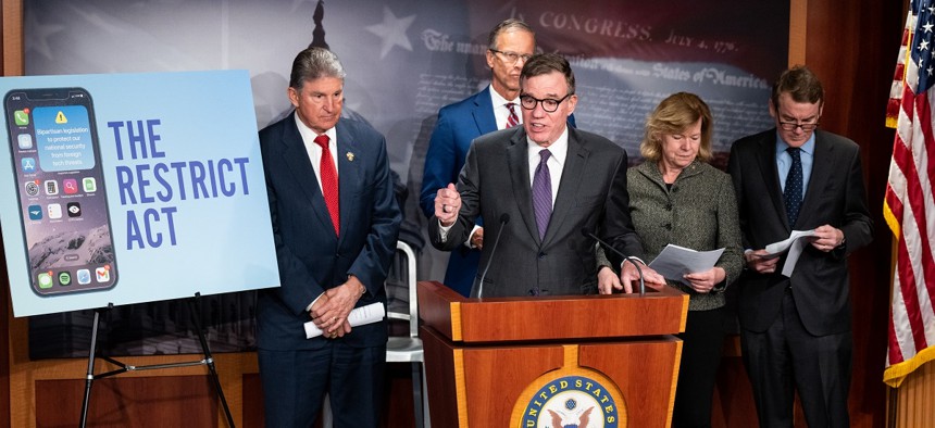 Sen. Mark Warner, D-Va., speaks during the news conference to introduce the Restricting the Emergence of Security Threats that Risk Information Communications Technology Act, or RESTRICT Act, in the Capitol on Tuesday, March 7, 2023. . Warner is flanked from left by Sen. Joe Manchin, D-W. Va., Sen. John Thune, R-S. Dak., Sen. Tammy Baldwin, D-Wisc., and Sen. Michael Bennet, D-Colo. 