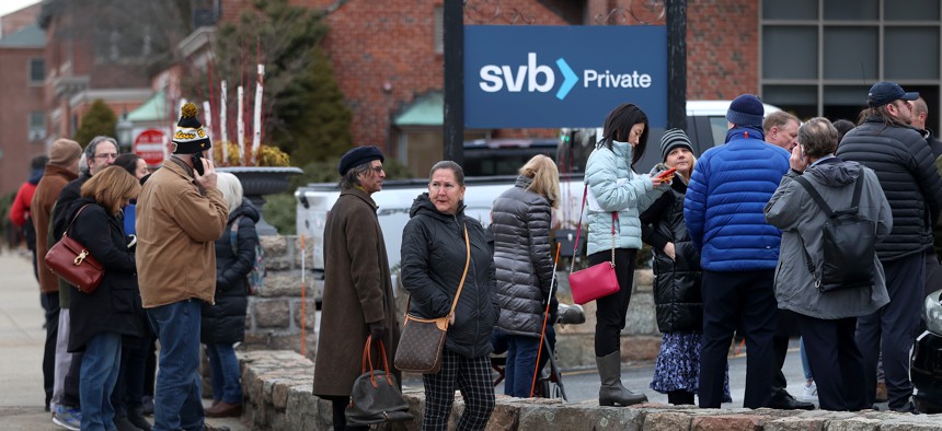 Customers line up outside Silicon Valley Bank in Wellesley, Massachusetts, on March 13, 2023, three days after the bank collapsed.