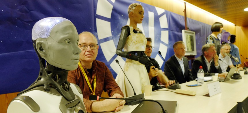  Human shaped robot Ameca (L), beside of Will Jackson, CEO and founder of British manufacturer Engineered Arts, addresses the media during a press conference on July 07, 2023 in Geneva, Switzerland.