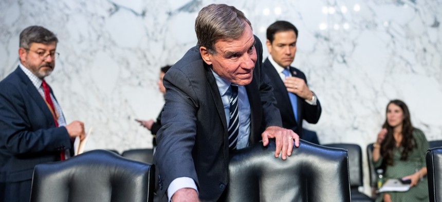 Sen. Mark Warner prepares to chair a hearing of the Senate Intelligence Committee in July 2023.