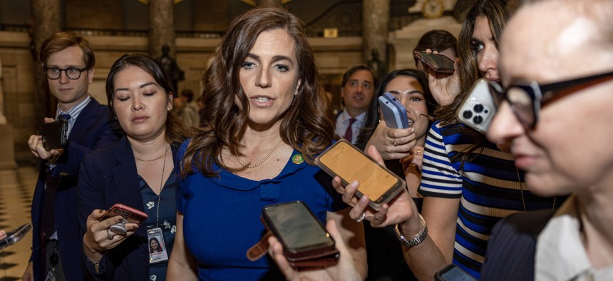 Rep. Nancy Mace, R-S.C., is trailed by reporters on Capitol Hill on April 26, 2023. Mace is lead sponsor of a rewrite of a key IT modernization bill.
