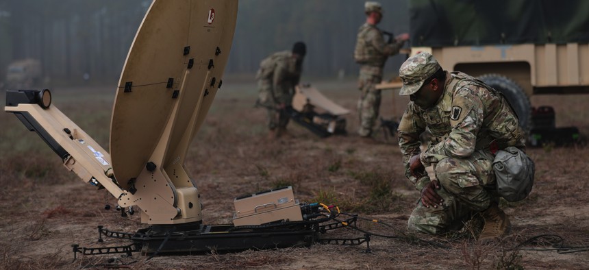 Soldiers from the 50th Expeditionary Signal Battalion-Enhanced, 35th Corps Signal Brigade, set up their equipment during a field training exercise on Oct. 26, 2022, at Fort Bragg, N.C.