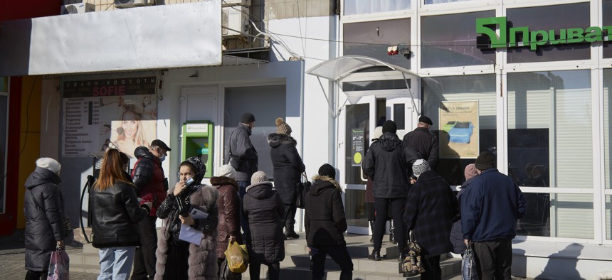 Customers wait outside a PrivatBank branch in Melitopol, Ukraine on February 15, 2022, just days before the Russian invasion.