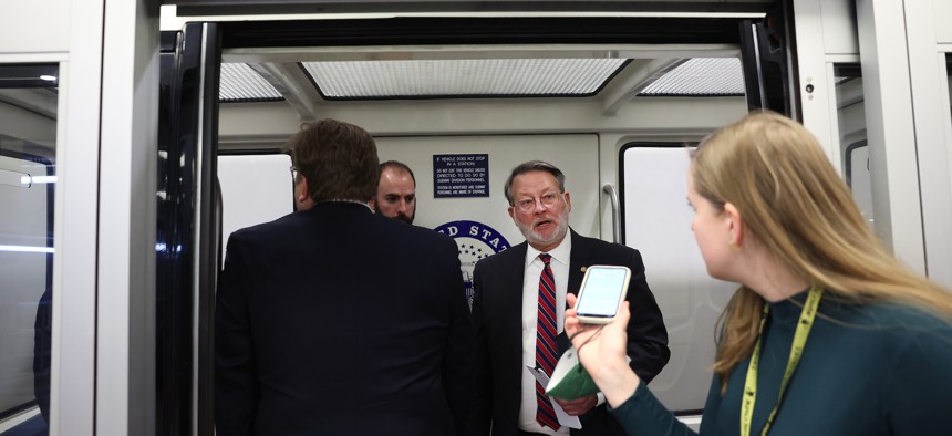 Sen. Gary Peters, D-Mich., talks to a reporter on the Senate subway