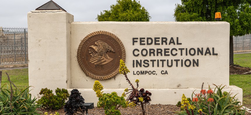 A sign near the entrance to the federal prison in Lompoc, Calif. A group of lawmakers want federal prisons to make sure released inmates have government issued identity cards.